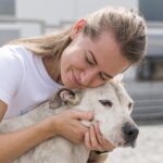 woman-showing-affection-cute-rescue-dog-shelter-scaled.jpg